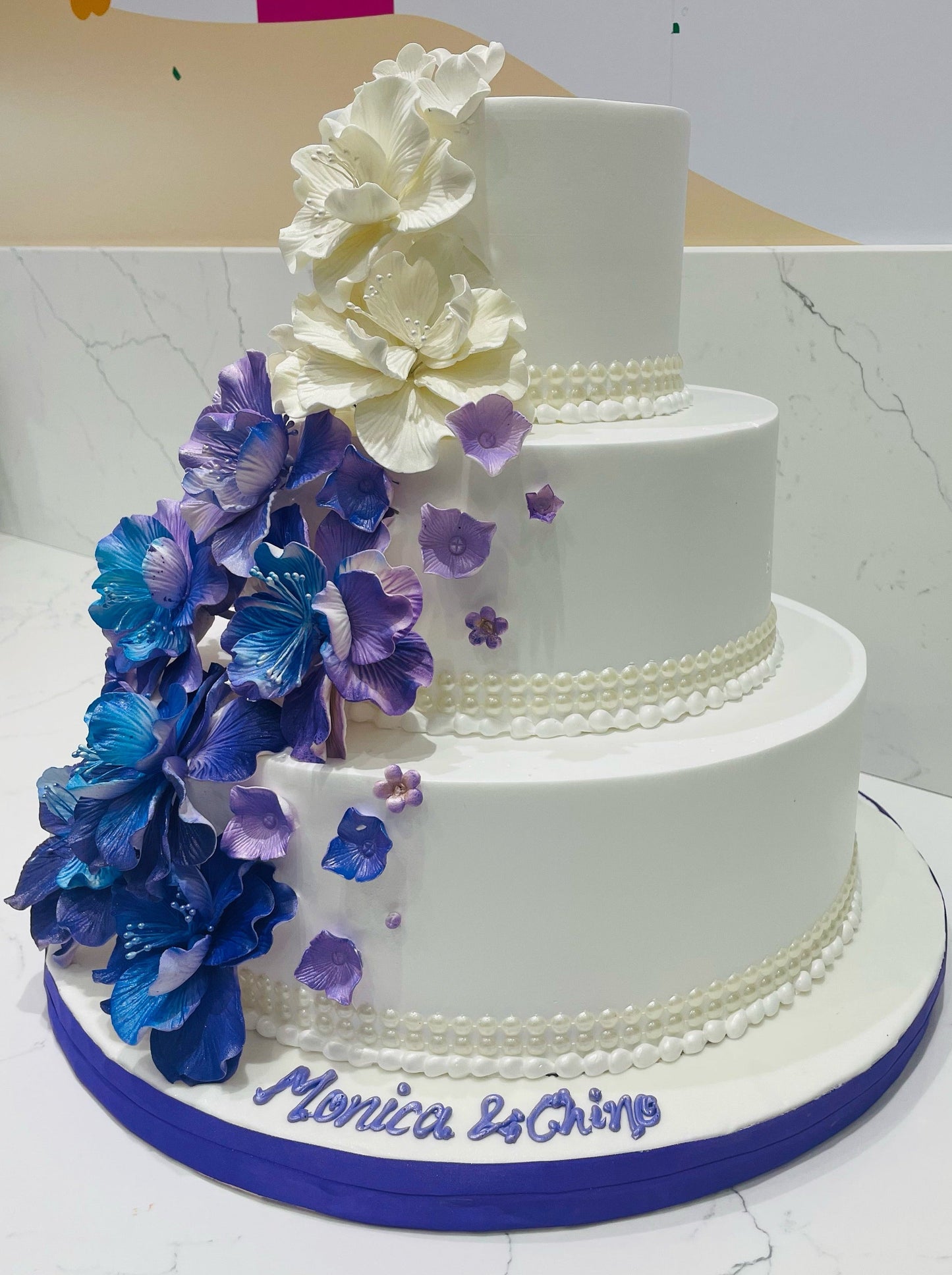 Purple & Blue Cascading Flowers Wedding Cake